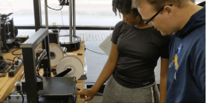 two students using a 3d printer